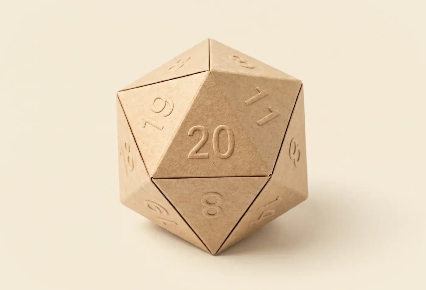 The Mega Roll box, a kraft-paper D20 with embossed numbers, on a cream background.